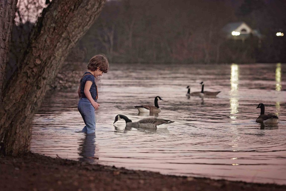 boy-and-canada-goose-at-river
